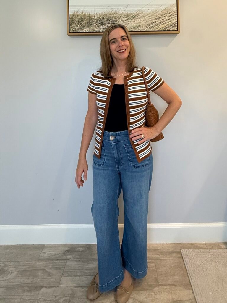 How to wear a cardigan with effortless style: Women wearing striped open front cardigan with jeans and brown woven handbag. 