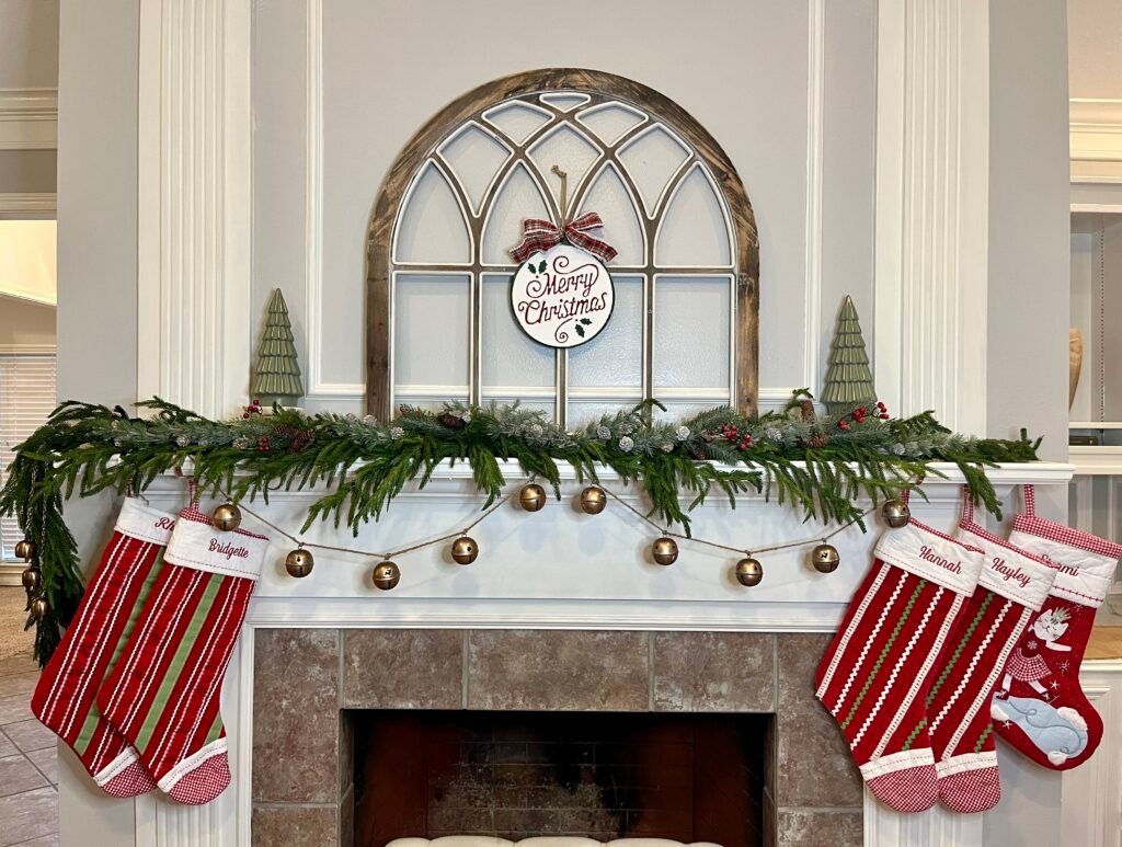 vintage-look gold bell garland strung across a fireplace mantel